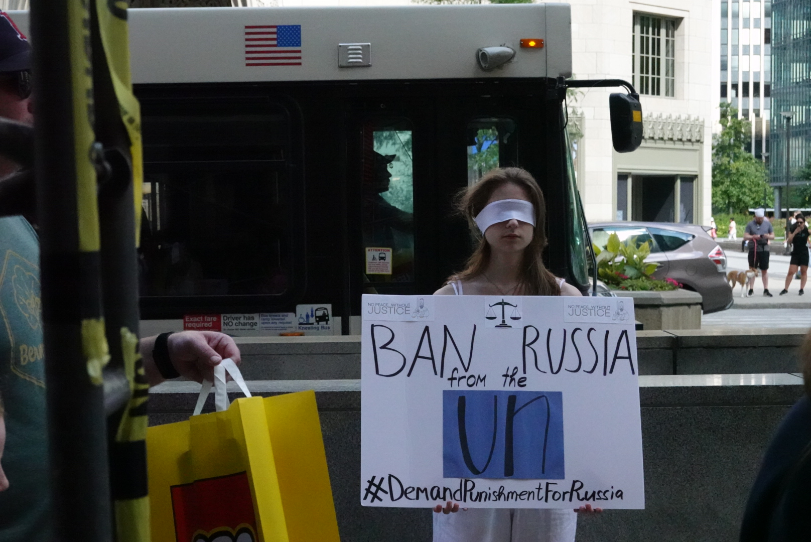 A protestor with a blindfold and sign in Chicago