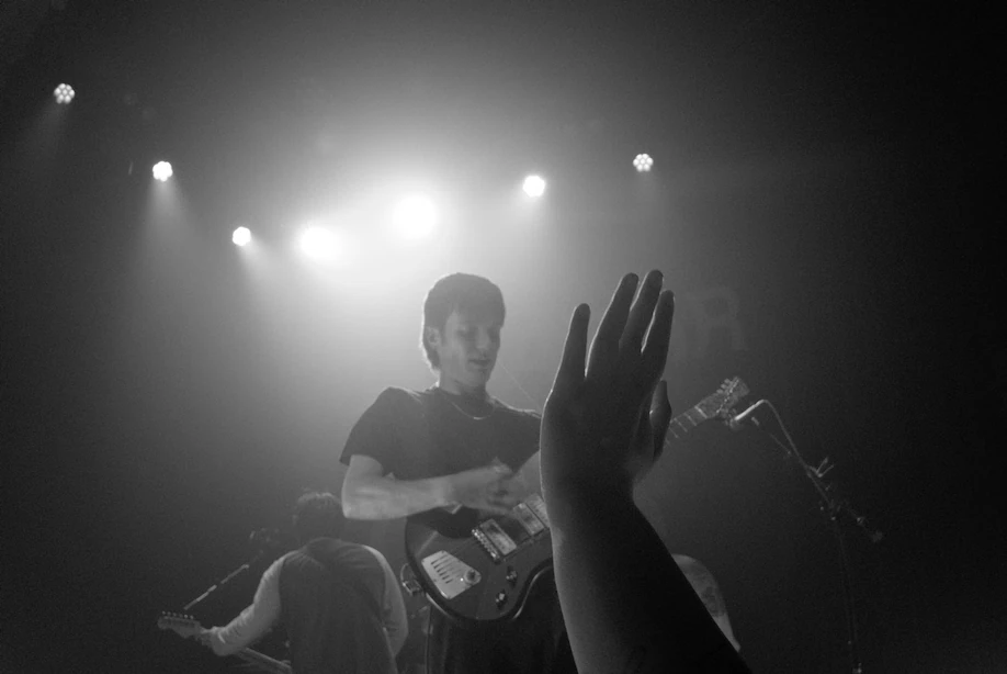 Black and white photo of a fan's hand reaching out towards Vundabar