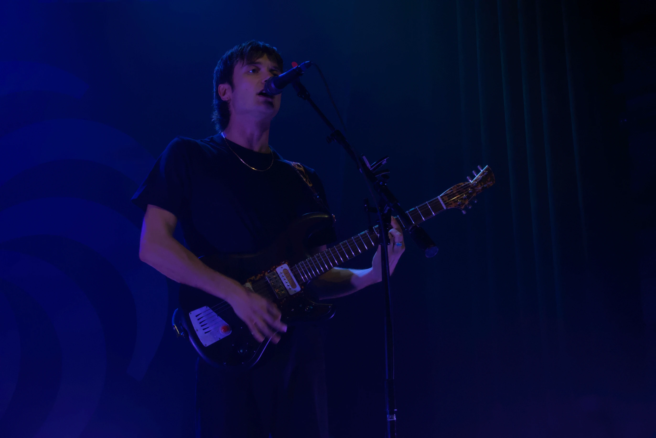 Vundabar's Brandon playing guitar in blue light
