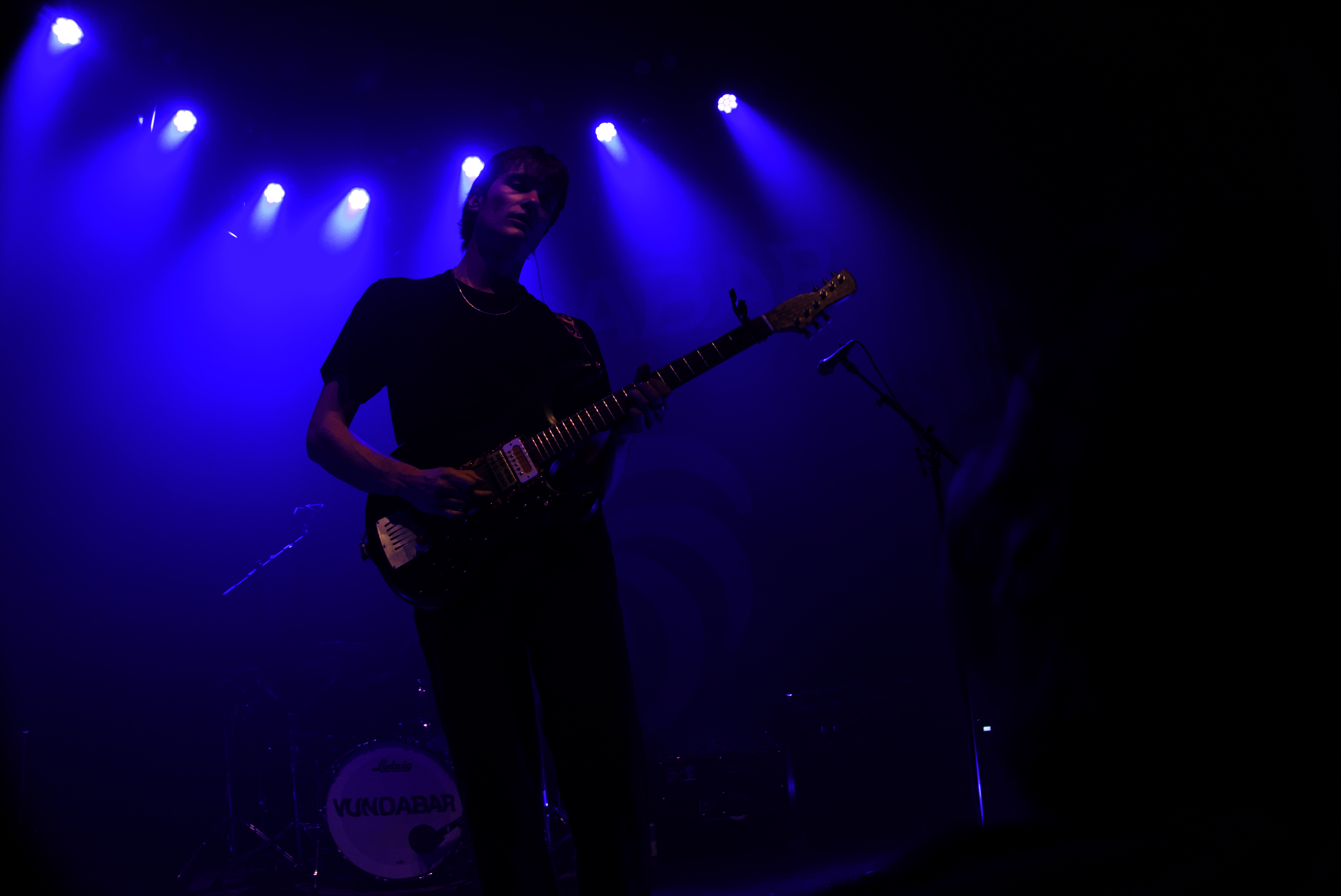 Vundabar's Brandon playing guitar in blue light