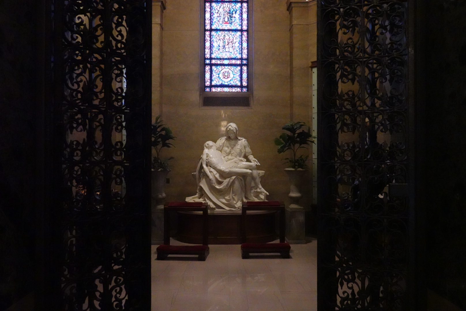 Far away shot of the Pieta in St Agnes Church in St Paul, framed by doors