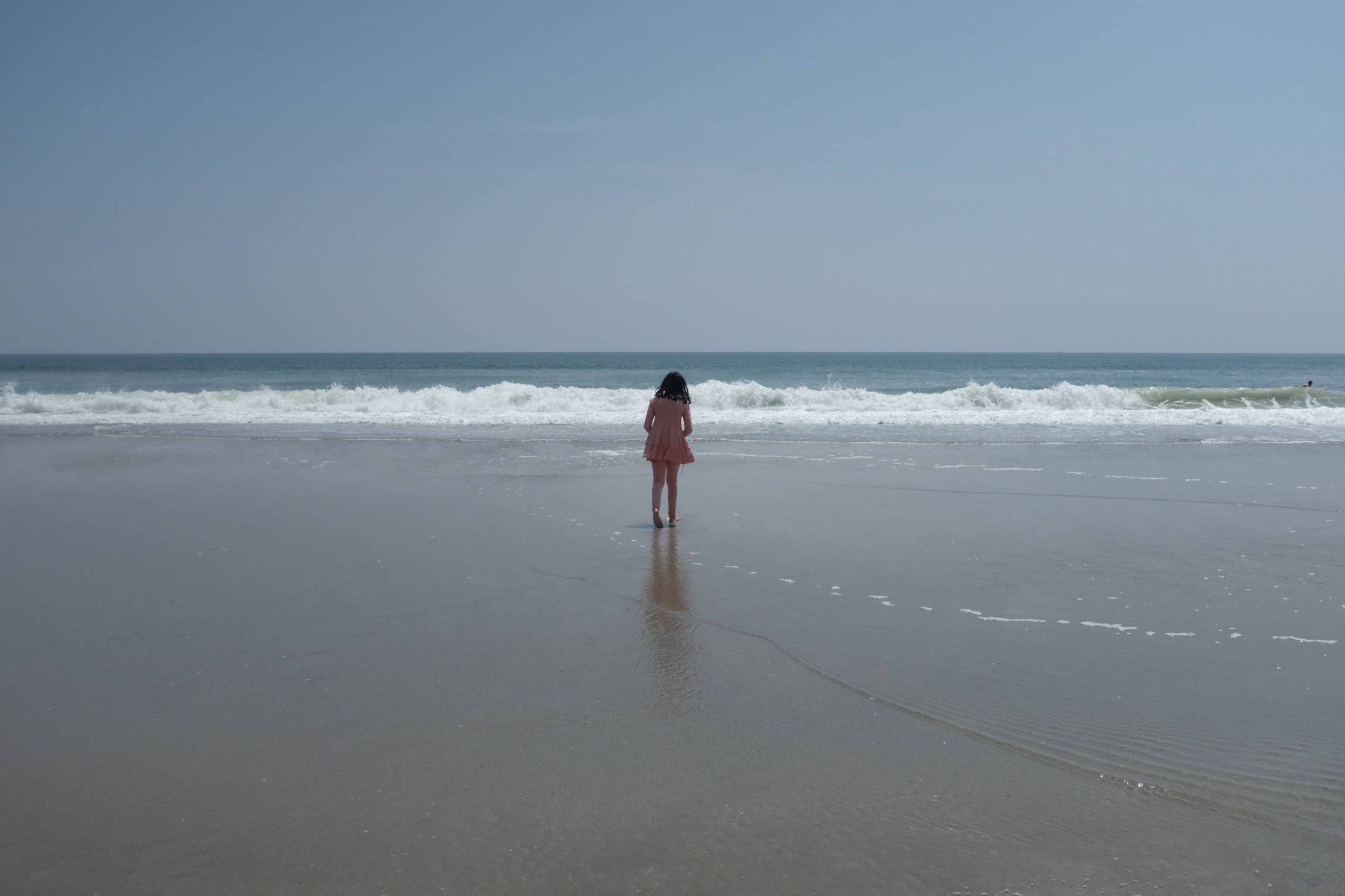 Shot of girl walking towards the ocean on Topsail Beach